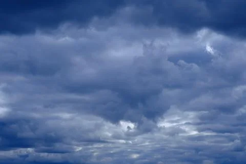 Dramatic high deep blue sky with fluffy clouds, cloudscape in stormy weather Photos