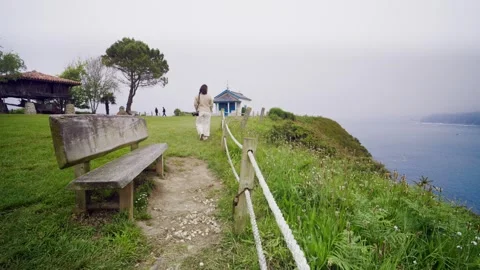 Dramatic high rocky cliff above a pristine sandy beach in Asturias, Spain Видео 336491345