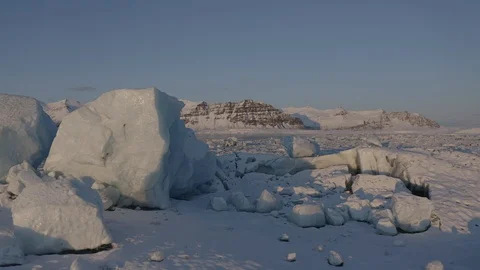 Dramatic ice rock passing camera in lagoon, 4K Video stock 127590171
