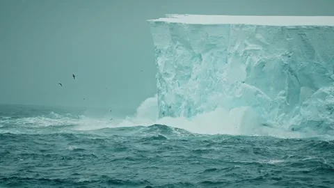 Dramatic Iceberg Calving with Splashing Waves in Arctic Waters Stock Footage 315094215