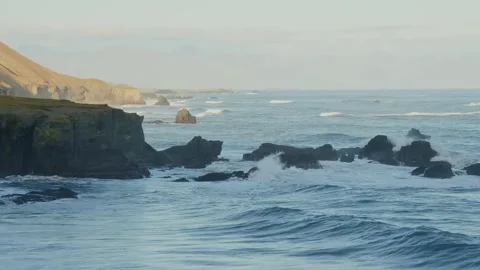 Dramatic Iceland Coastline with Crashing Waves and Rugged Cliffs Stock Footage 320202398