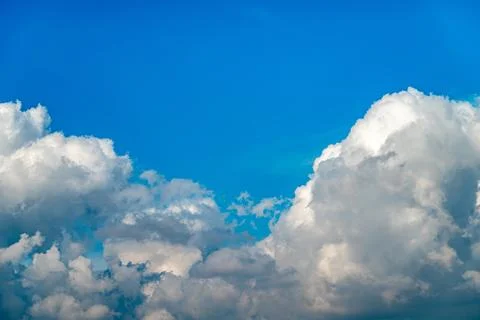 Dramatic image of bright blue sky with fluffy white clouds Stock Photos