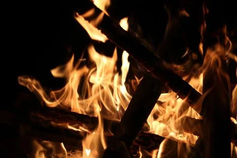 Dramatic image of burning embers in fire with charred pieces of wood Stock Photos
