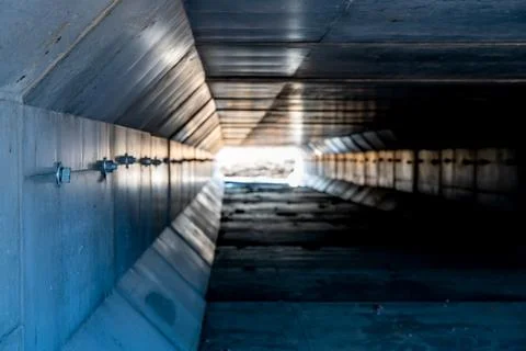 Dramatic Image inside a concrete box culvert under a road for stormwater Stock Photos