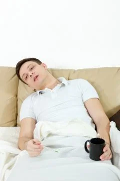 Dramatic image of sick man laying in bed with fever Stock Photos