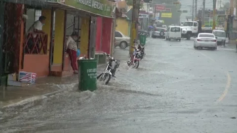 Dramatic image of small caribbean town durring a rainstorm with flooded streets Stock Footage 156135959