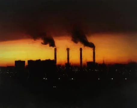 Dramatic industrial chimneys during sunset illustration Foto stock