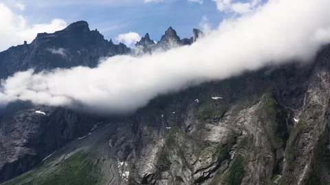 Dramatic Jagged Mountains of Troll Wall in Norway Surrounded by Cloud Stock Footage 252612010
