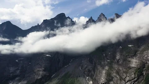 Dramatic Jagged Mountains of Troll Wall in Norway Surrounded by Cloud Stock Footage 252612083