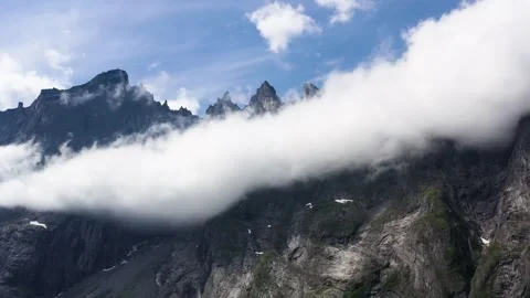 Dramatic Jagged Mountains of Troll Wall in Norway Surrounded by Cloud Stock Footage 252612498