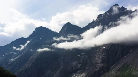 Dramatic Jagged Mountains of Troll Wall in Norway Surrounded by Cloud Stock Footage 252612893