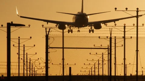 DRAMATIC JET LANDS AT SUNSET 4 Stock Footage 63319871