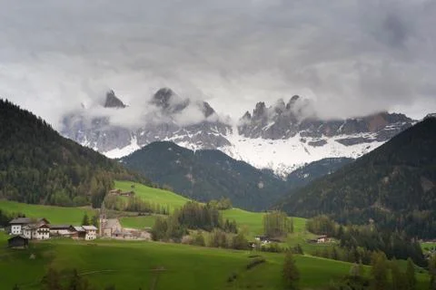 Dramatic landscape and dark cloud over Val di funes Dlomite italy Stock Photos