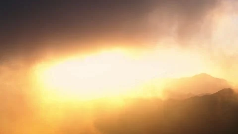A dramatic landscape of the bright orange sun rising over beautiful mountain  Stock Footage 329236178