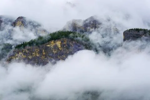 Dramatic landscape of Cascade Mountain in Banff covered by thick clouds and f Stock Photos