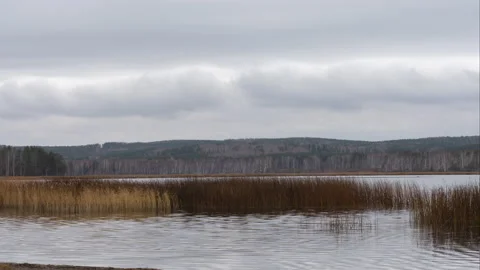 Dramatic landscape: cloudy sky with clouds is reflected in the water of the lake Stock Footage 170008078