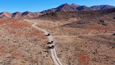 A dramatic landscape of color and texture is traveled by offroaders as Stock Footage 125720542