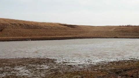 A dramatic landscape of a dry lake. Dry bottom of a dried-up lake in large Stock Footage 142098092