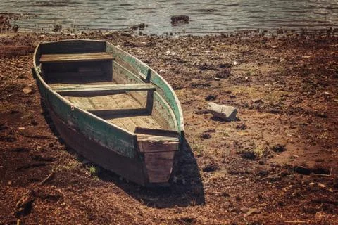 Dramatic landscape with old boat on the shore Stock Photos