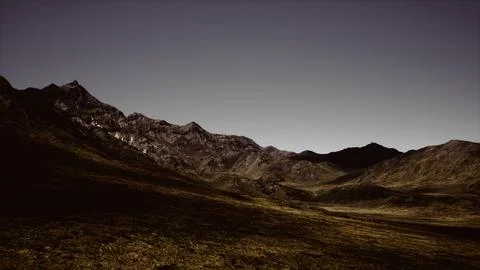 Dramatic landscape of rugged mountains under a dark sky at twilight Stockillustratie