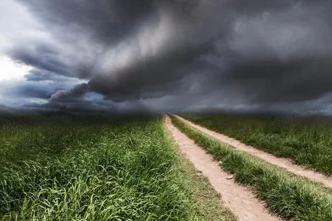 Dramatic landscape with a rural road. Stock Photos