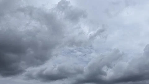 A dramatic landscape shot captures vast expanses of dark, heavy storm cloud.. 写真素材