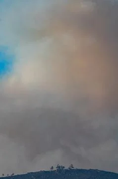 Dramatic Landscape with Smoke and Blue Sky Contrast Foto stock