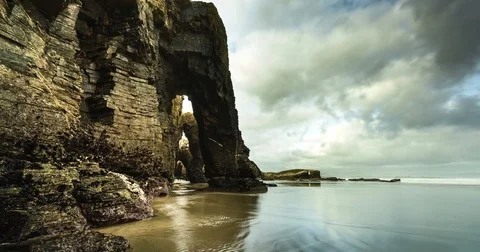 Dramatic landscape time lapse with drifting clouds, water and rocks. Stock Footage 77917571