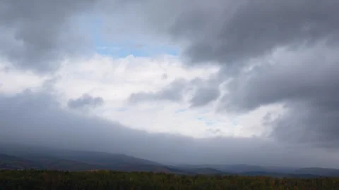 Dramatic landscape transition with rolling clouds and vibrant autumn foliage Stock Footage 319474821