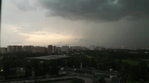 Dramatic landscape view of dark storm clouds fighting golden sunlight Stock Footage 338395355