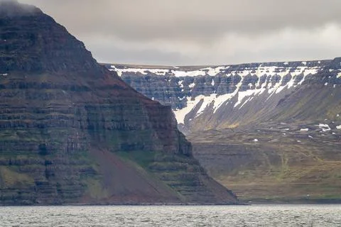 Dramatic landscape view of mountains and sea in Iceland, near Isafjordur, under Stock Photos