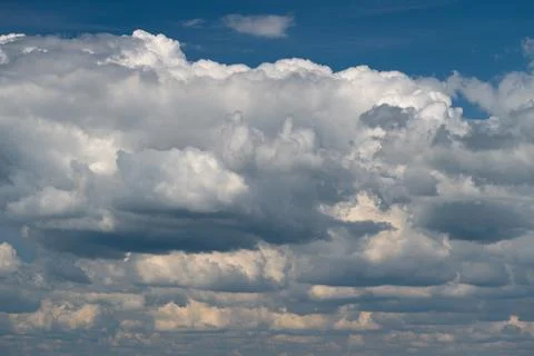 Dramatic layered cumulus clouds across a blue sky Stock Photos