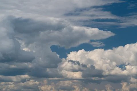 Dramatic layered cumulus clouds against a deep blue sky Stock Photos