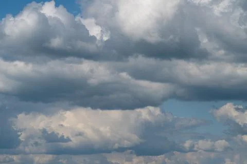 Dramatic layered cumulus clouds filling a blue sky Photos
