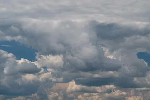 Dramatic layered cumulus clouds filling the sky with soft sunlight Photos