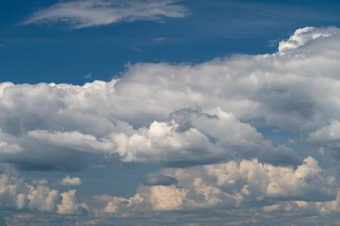 Dramatic layered cumulus clouds under blue sky Stock Photos