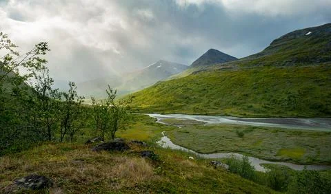 Dramatic light and clouds over ermote arctic valley on a cloudy day of summer Stock Photos