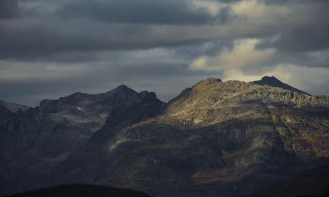 Dramatic light and clouds over mountain peaks of northern norway Stock Photos