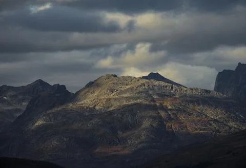 Dramatic light and clouds over mountain peaks of northern norway Stock Photos