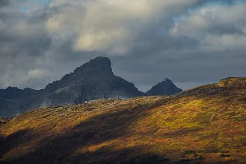Dramatic light and clouds over mountain peaks of northern norway Stock Photos