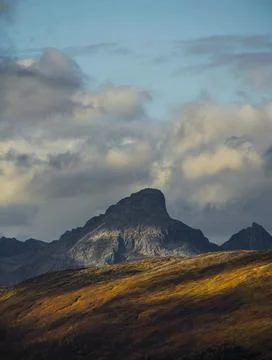 Dramatic light and clouds over mountain peaks of northern norway Stock Photos