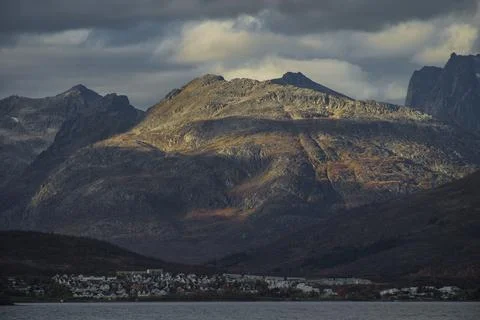 Dramatic light and clouds over mountain peaks around Tromso northern norway Stock Photos