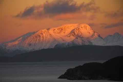 Dramatic light and clouds over mountain peaks around Tromso northern norway Stock Photos