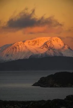 Dramatic light and clouds over mountain peaks around Tromso northern norway Stock Photos