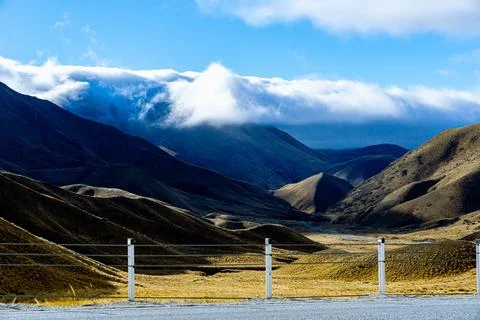 Dramatic Light and Clouds Over Desert Hills in South Island, New Zealand Stock Photos