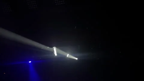 Dramatic light beam cutting through darkness creating an atmospheric stage Stock Footage 313636358