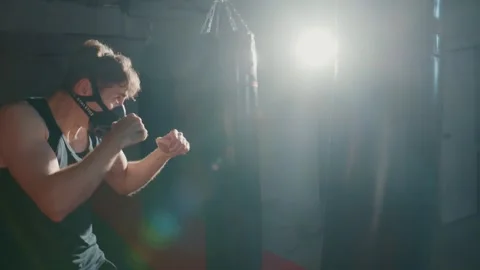 Dramatic light beams cut through dark gym space Video stock 331342189