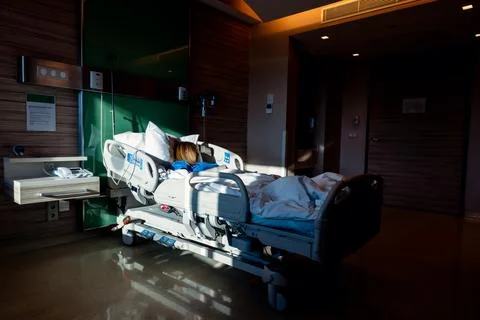 Dramatic Light Entering His Room While The Patient Is Lying In The Hospital Stock Photos