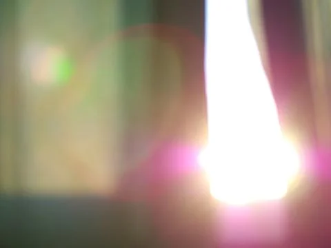 Dramatic light leak through green curtain bokeh Foto stock