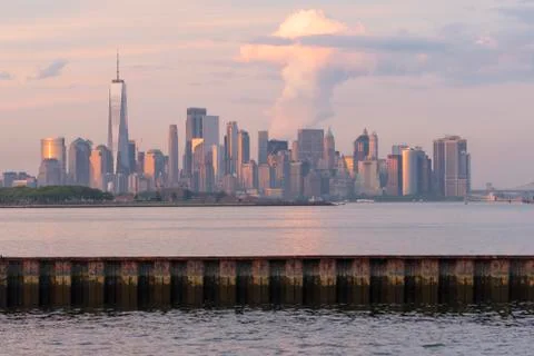 Dramatic Light Reflects off the Buildings and Infrastructure of Manhattan NY Stock Photos